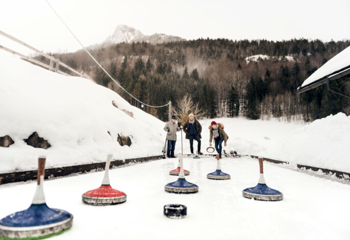 Eisstockschießen auf der Natureisbahn bei der Waldhofalm am Fuschlsee.