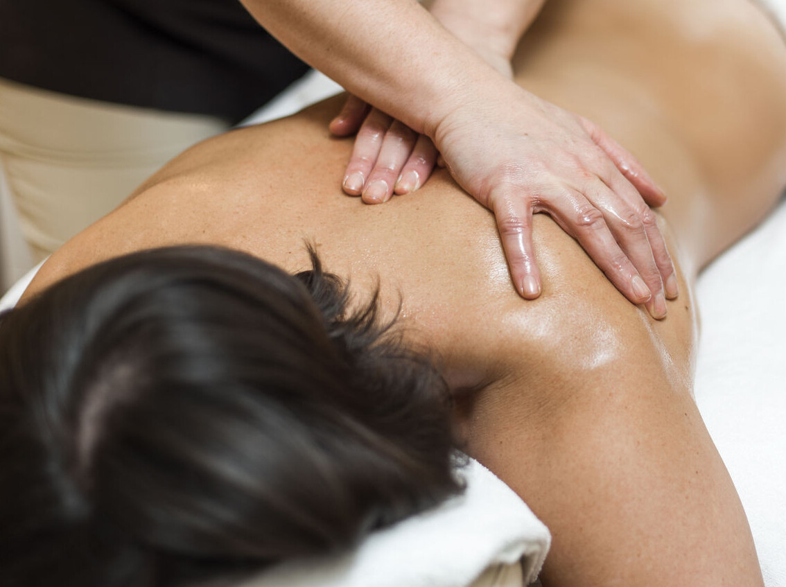 A person receiving a relaxing back massage at Waldhof Fuschlsee Resort. 