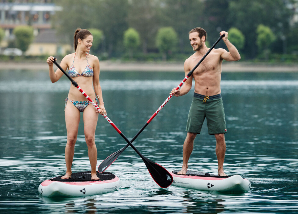 Two people paddleboarding on lake Fuschl.
