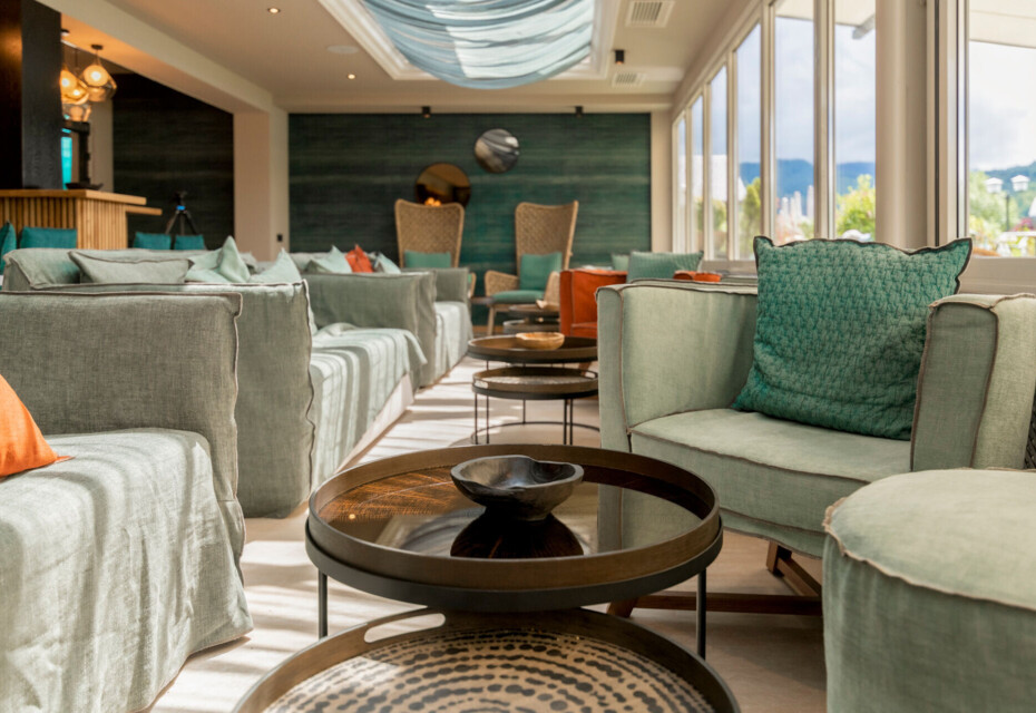 Lounge area at Seebar with comfortable seating and stylish decor, featuring large windows overlooking scenic views.