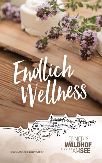 Spa amenities with flowers and text "Finally Wellness" at Waldhof Fuschlsee Resort.