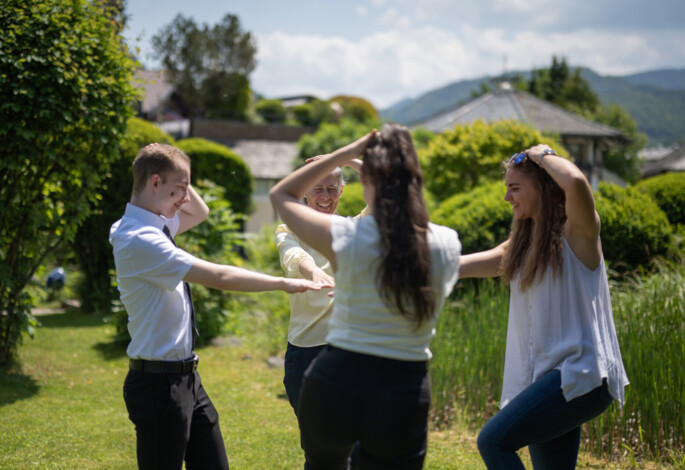 People enjoying a fun activity in a lush, scenic garden setting.