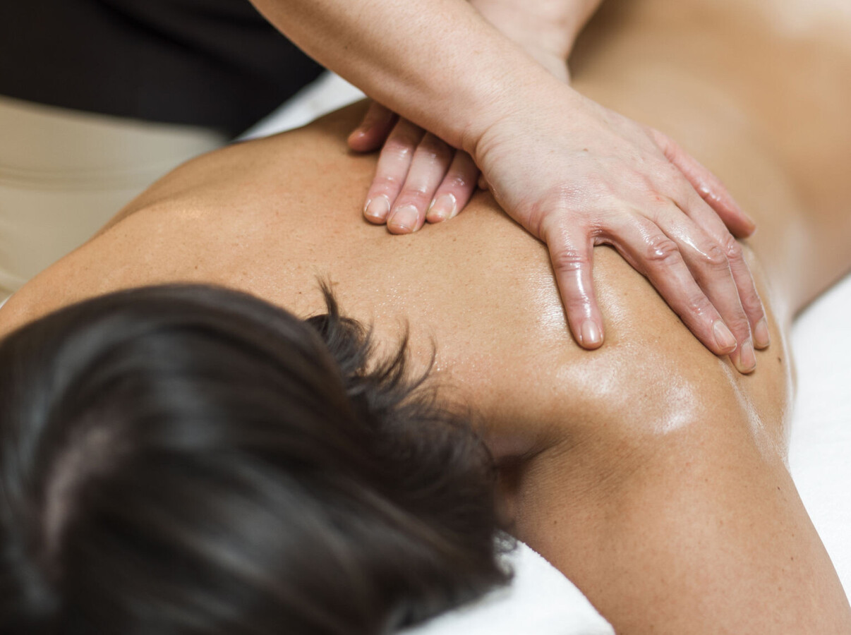 Person receiving a back massage at Waldhof Fuschlsee Resort. 